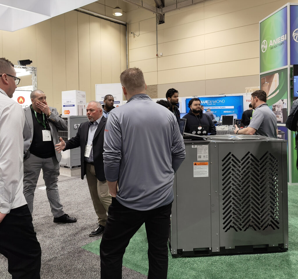 Brad Monaghan, North American Sales Manager at ANESI, speaks with Equipco LTD representatives during the CMPX 2024 in Toronto.